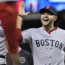 Boston Red Sox' Cody Ross celebrates after the Red Sox beat the Minnesota Twins 6-5 in a baseball game Monday, April 23, 2012, in Minneapolis. Ross had three RBI and two home runs. (AP Photo/Jim Mone)