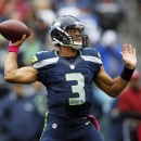 Seattle Seahawks quarterback Russell Wilson throws in the first half of an NFL football game against the New England Patriots, Sunday, Oct. 14, 2012, in Seattle. (AP Photo/John Froschauer)