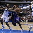 Dallas Mavericks' Darren Collison (4) pressures Sacramento Kings' Isaiah Thomas (22) as Mavericks' Vince Carter (25) attempts to strip the ball in the first half of an NBA basketball game Wednesday, Feb. 13, 2013, in Dallas. Carter was charged with a foul on the play. (AP Photo/Tony Gutierrez)