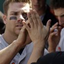 Baltimore Orioles' Chris Davis celebrates in the dugout after scoring on a two-run single by J.J. Hardy during the seventh inning of a baseball game against the Kansas City Royals, Thursday, May 17, 2012, in Kansas City, Mo. (AP Photo/Charlie Riedel)