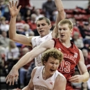 Wisconsin's Mike Bruesewitz (31) drives past Nebraska's Brandon Ubel (13) with teammate Jared Berggren, rear, in the first half of an NCAA college basketball game in Lincoln, Neb., Sunday, Jan. 6, 2013. (AP Photo/Nati Harnik)