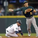 Seattle Mariners' Miguel Olivo is forced out at second as Oakland Athletics shortstop Stephen Drew makes a throw to first attempting a double play on Trayvon Robinson during the second inning of a baseball game in Seattle, Saturday, Sept. 8, 2012. The double play failed and a run scored. (AP Photo/John Froschauer)