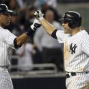New York Yankees' Russell Martin, right, is greeted by teammate Derek Jeter after he hit a grand slam during the fourth inning of a baseball game against the Tampa Bay Rays at Yankee Stadium in New York, Tuesday, June 5, 2012.  (AP Photo/Seth Wenig)