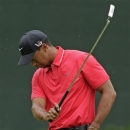 Tiger Woods swings his putter after his bogey on the fifth hole during the fourth round of the Masters golf tournament Sunday, April 14, 2013, in Augusta, Ga. (AP Photo/Charlie Riedel)