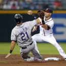 Colorado Rockies' Tyler Colvin (21) slides before being tagged out at second base by Atlanta Braves shortstop Paul Janish on an attempted steal during the second inning of a baseball game Tuesday, Sept. 4, 2012, in Atlanta. (AP Photo/John Bazemore)