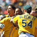 OAKLAND, CA - JUNE 24: Derek Norris #36 of the Oakland Athletics (center, behind Blackley) is congratulated by teammates after hitting a three-run walk-off home run against the San Francisco Giants during the ninth inning of an interleague game at O.co Coliseum on June 24, 2012 in Oakland, California. The Oakland Athletics defeated the San Francisco Giants 4-2. (Photo by Jason O. Watson/Getty Images)