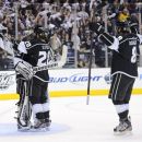 Los Angeles Kings goalie Jonathan Quick,  left, Jarret Stoll, center, and Drew Doughty celebrate their 2-1 win against the Phoenix Coyotes during Game 3 of the NHL hockey Stanley Cup Western Conference finals, Thursday, May 17, 2012, in Los Angeles. The Kings won 2-1. (AP Photo/Mark J. Terrill)