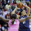 Connecticut's Stefanie Dolson (31) looks to make a pass as she is defended by Rutgers' Monique Oliver (34) during the first half of an NCAA college basketball game Saturday, Feb. 16, 2013, in Piscataway, N.J. (AP Photo/Mel Evans)