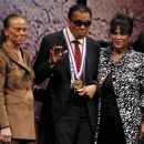 Boxing great Muhammad Ali waves after being awarded the Liberty Medal, as his wife Lonnie (L) and sister-in-law Marilyn Williams (R) look on, at the National Constitution Center in Philadelphia, Pennsylvania September 13, 2012. Ali, retired world heavyweight title holder, received the $100,000 award, sponsored by the nonprofit National Constitution Center, in recognition for his humanitarian efforts and work for civil rights at an awards ceremony on Thursday. REUTERS/Tim Shaffer