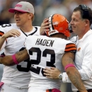 Cleveland Browns head coach Pat Shurmur, right, hugs cornerback Joe Haden (23) as quarterback Brandon Weeden, left, watches in the fourth quarter of an NFL football game, Sunday, Oct. 14, 2012, in Cleveland. The Browns won 34-24. (AP Photo/Tony Dejak)