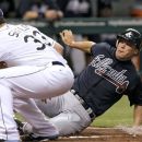 Atlanta Braves' Chipper Jones, right, scores from third base ahead the tag by Tampa Bay Rays starting pitcher James Shields on a second inning wild pitch by Shields during an interleague baseball game, Friday, May 18, 2012, in St. Petersburg, Fla. (AP Photo/Chris O'Meara)