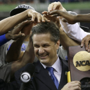 FILE - In this April 2, 2012 file photo, Kentucky head coach John Calipari, center, celebrates with his team after the NCAA Final Four tournament college basketball championship game against Kansas , in New Orleans. Kentucky and its roster full of high school All-Americas is the narrow choice over Michigan State in The Associated Press' preseason college basketball poll, released Thursday, Oct. 31, 2013. (AP Photo/David J. Phillip, File)