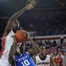 Kentucky guard Archie Goodwin (10) attempts to shoot while defended by Georgia forward/center John Florveus (32) during the first half of an NCAA college basketball game in Athens, Ga., Thursday, March 7, 2013. (AP Photo/The Athens Banner-Herald, AJ Reynolds)