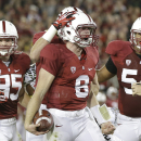 Stanford quarterback Kevin Hogan (8) celebrates with fullback Ryan Hewitt (85), tight end Charlie Hopkins (obscured) and guard David Yankey (54) after running for an 11-yard touchdown against Oregon during the second quarter of an NCAA college football game in Stanford, Calif., Thursday, Nov. 7, 2013. (AP Photo/Marcio Jose Sanchez)