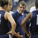 Connecticut coach Geno Auriemma speaks with Kelly Faris (34) as Brianna Banks (13) listens during practice before the NCAA college basketball team's media day in Storrs, Conn., Tuesday, Oct. 16, 2012. (AP Photo/Jessica Hill)