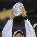 Auburn head coach Gene Chizik holds up the Coaches' Trophy after beating Oregon 22-19 in the BCS National Championship NCAA college football game Monday, Jan. 10, 2011, in Glendale, Ariz.  (AP Photo/Mark J. Terrill)