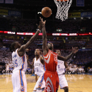 OKLAHOMA CITY, OK - APRIL 24:  Patrick Beverley #12 of the Houston Rockets lays up a shot past Reggie Jackson #15 of the Oklahoma City Thunder during the first half of Game Two of the Western Conference Quarterfinals of the 2013 NBA Playoffs at Chesapeake Energy Arena on April 24, 2013 in Oklahoma City, Oklahoma. The Thunder defeated the Rockets 105-102.  (Photo by Christian Petersen/Getty Images)