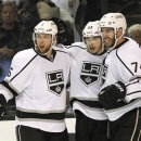 Los Angeles Kings right wing Dustin Brown, center, celebrates with teammates defenseman Jake Muzzin (6) and center Dwight King (74) after scoring a goal against the San Jose Sharks during the second period in Game 6 of their second-round NHL hockey Stanley Cup playoff series in San Jose, Calif., Sunday, May 26, 2013. (AP Photo/Tony Avelar)