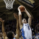 Duke's Mason Plumlee (5) shoots over North Carolina's James Michael McAdoo (43) during the first half of an NCAA college basketball game in Durham, N.C., Wednesday, Feb. 13, 2013. (AP Photo/Gerry Broome)