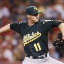 Oakland Athletics starting pitcher Jarrod Parker throws in the first inning of a baseball game against the Los Angeles Angels in Anaheim, Calif., Monday, Sept. 10, 2012. (AP Photo/Jae C. Hong)