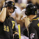 Pittsburgh Pirates' Russell Martin (55) celebrates with Pittsburgh Pirates starting pitcher A.J. Burnett (34) after hitting a three-run home run off St. Louis Cardinals starting pitcher Lance Lynn (31) during the third inning of a baseball game in Pittsburgh Saturday, Aug. 31, 2013. (AP Photo/Gene J. Puskar)