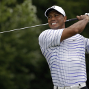 Tiger Woods winces after tee shot on the sixth hole during the second round of the PGA Championship golf tournament at Valhalla Golf Club on Friday, Aug. 8, 2014, in Louisville, Ky. (AP Photo/Jeff Roberson)