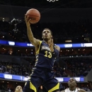 Marquette guard Vander Blue (13) shoots past Miami forward Kenny Kadji (35), and guard Durand Scott (1) during the first half of an East Regional semifinal in the NCAA college basketball tournament on Thursday, March 28, 2013, in Washington. (AP Photo/Pablo Martinez Monsivais)