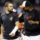 Baltimore Orioles' Nick Markakis, left, leaves the field with his thumb wrapped after celebrating their 5-4 win over the New York Yankees in a baseball game, Saturday, Sept. 8, 2012, in Baltimore. Markakis was hit by a pitch from Yankees' CC Sabathia in the fifth inning. (AP Photo/Nick Wass)