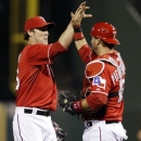 Texas Rangers closer Joe Nathan, left, high-fives catcher A.J. Pierzynski (12) after the final out of a baseball game against the Tampa Bay Rays, Monday, April 8, 2013, in Arlington, Texas. The Rangers won 5-4. (AP Photo/LM Otero)