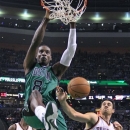 Boston Celtics forward Jeff Green (8) dunks against Oklahoma City Thunder forward Nick Collison (4) and center Hasheem Thabeet (34) during the first half of an NBA basketball game in Boston, Friday, Nov. 23, 2012. (AP Photo/Elise Amendola)