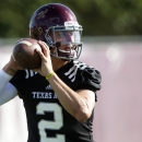 FILE - In this Aug. 5, 2013, file photo, Texas A&M quarterback Johnny Manziel throws during NCAA college football practice in College Station, Texas. Texas A&M coaches and players are talking only about Rice, their opening opponent Saturday. What they're not talking about is Manziel and the NCAA investigation into whether he was paid for autographs. (AP Photo/Patric Schneider, File)