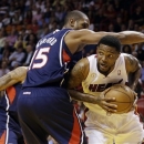 Atlanta Hawks' Al Horford (15) pressures Miami Heat's Udonis Haslem (40) during the first half of an NBA basketball game in Miami, Tuesday, March 12, 2013. (AP Photo/J Pat Carter)