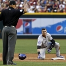 Colorado Rockies' Troy Tulowitzki, right, pauses at second base after being forced out as umpire Kerwin Danley makes the call in the fifth inning during a baseball game against the Arizona Diamondbacks, on Saturday, April 27, 2013, in Phoenix. AP Photo/Ross D. Franklin)