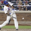 New York Mets' Marlon Byrd hits a two-run home run during the sixth inning of a baseball game against the Atlanta Braves Tuesday, Aug. 20, 2013, in New York. (AP Photo/Frank Franklin II)