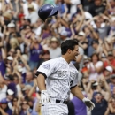Colorado Rockies' Nolan Arenado celebrates by tossing his helmet after hitting the game-winning RBI-single against the San Francisco Giants in the ninth inning of the Rockies' 2-1 victory in a baseball game in Denver on Saturday, June 29, 2013. (AP Photo/David Zalubowski)