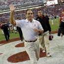 Alabama head coach Nick Saban waves to fans as he runs off the field following a 45-10 win over Tennessee in an NCAA college football game in Tuscaloosa, Ala., Saturday, Oct. 26, 2013. (AP Photo/Dave Martin)