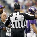 Minnesota Vikings head coach Leslie Frazier, left, talks with side judge Dwayne Strozier, right, during the second half of an NFL football game against the San Francisco 49ers Sunday, Sept. 23, 2012, in Minneapolis. The Vikings won 24-13. (AP Photo/Genevieve Ross)