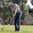 John Merrick makes his second shot on the second fairway in the third round of the Northern Trust Open golf tournament at Riviera Country Club in the Pacific Palisades area of Los Angeles Saturday, Feb. 16, 2013. (AP Photo/Reed Saxon)