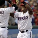Texas Rangers' Adrian Beltre, right, celebrates with Elvis Andrus after Beltre's home run during the fourth inning of a baseball game against the Baltimore Orioles, Wednesday, Aug. 22, 2012, in Arlington, Texas. (AP Photo/LM Otero)
