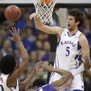 Kansas center Jeff Withey (5) blocks a shot by Kansas State guard Shane Southwell (1) during the first half of an NCAA college basketball game for the Big 12 men's tournament title Saturday, March 16, 2013, in Kansas City, Mo. (AP Photo/Orlin Wagner)