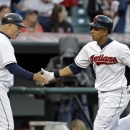 Cleveland Indians' Michael Brantley, right, is congratulated by third base coach Brad Mills after hitting a solo home run off Kansas City Royals starting pitcher Luis Mendoza in the fifth inning of a baseball game on Wednesday, June 19, 2013, in Cleveland. (AP Photo/Mark Duncan)