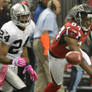 Atlanta Falcons wide receiver Roddy White (84) works for a long passed ball as Oakland Raiders cornerback Michael Huff (24) looks on during the second half of an NFL football game, Sunday, Oct. 14, 2012, in Atlanta. (AP Photo/Rich Addicks)