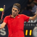 Switzerland's Roger Federer returns a ball to Uzbekistan's Denis Istomin during their round of sixteen match at the Swiss Indoor tennis tournament at the St. Jakobshalle in Basel, Switzerland, on Thursday, Oct. 23, 2014. (AP Photo/Keystone, Georgios Kefalas)