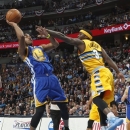 Golden State Warriors guard Jarrett Jack, left, goes up for a shot as Denver Nuggets guard Ty Lawson covers in the first quarter of Game 2 of the teams' NBA first-round playoff series in Denver on Tuesday, April 23, 2013. (AP Photo/David Zalubowski)