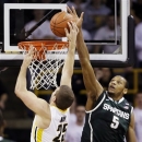 Michigan State center Adreian Payne (5) tries to block a shot by Iowa forward Eric May during the first half of an NCAA college basketball game, Thursday, Jan. 10, 2013, in Iowa City, Iowa. (AP Photo/Charlie Neibergall)