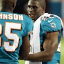 Miami Dolphins' Reggie Bush, right, talks to teammate Chad Johnson during the first half of an NFL preseason football game against the Tampa Bay Buccaneers, Friday, Aug. 10, 2012, in Miami. (AP Photo/Wilfredo Lee)