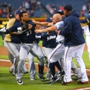 Milwaukee Brewers Carlos Gomez, left, and Atlanta Braves Reed Johnson, right, exchange blows when both benches clear following a home run by Gomez in the first inning of a baseball game Wednesday, Sept. 25, 2013 in Atlanta. (AP Photo/Atlanta Journal-Constitution, Curtis Compton)