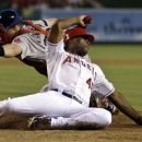 Los Angeles Angels' Torii Hunter, right, slides under the tag of Boston Red Sox catcher Ryan Lavarnway scoring on a hit by Albert Pujols during the first inning of an baseball in Anaheim, Calif., Wednesday, Aug. 29, 2012. (AP Photo/Chris Carlson)
