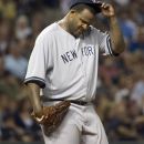 New York Yankees pitcher CC Sabathia, reacts after throwing a pitch in the dirt against the Cleveland Indians, in the sixth inning of a baseball game in Cleveland, Friday, Aug. 24, 2012. (AP Phil Long)