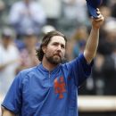 New York Mets starting pitcher R.A. Dickey tips his cap to the crowd as he celebrates his 20th victory of the season after the Mets 6-5 win against the Pittsburgh Pirates in a baseball game at Citi Field in New York, Thursday, Sept. 27, 2012. (AP Photo/Kathy Willens)
